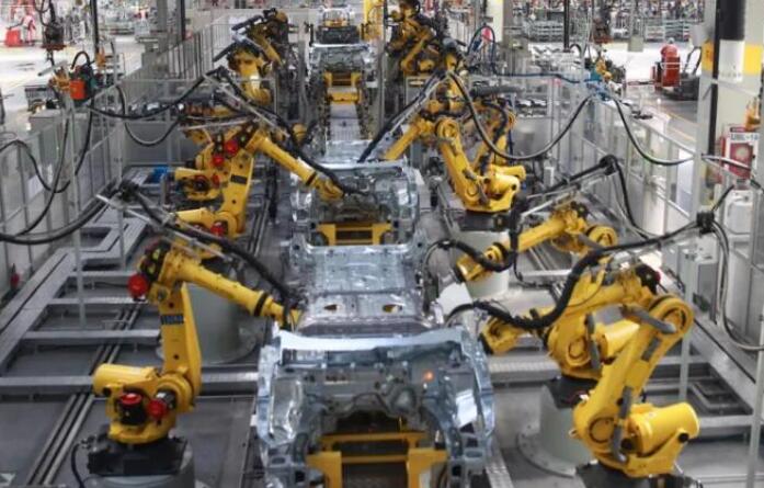 Modern manufacturing facility with robotic welding equipment, industrial robots working on metal components with bright welding arcs, blue and orange lighting, high-tech production environment